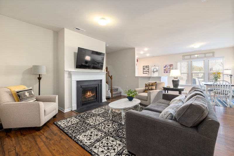 Spacious living room featuring a fireplace, TV, and comfortable seating arrangement